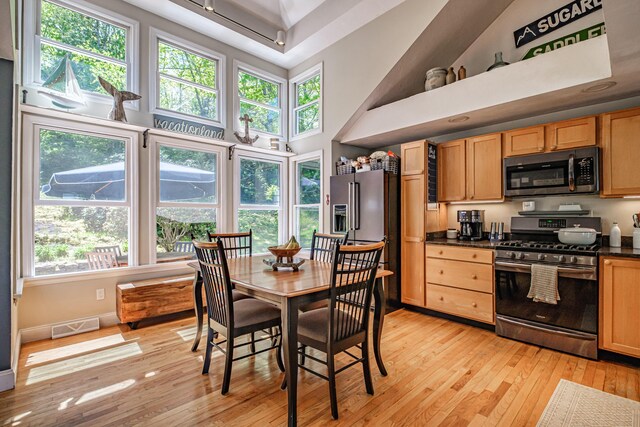 543 Middle Rd, Dresden, ME 04342 - dining room with light wood-style floors, a towering ceiling, and baseboards