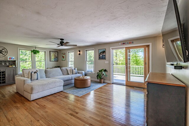 543 Middle Rd, Dresden, ME 04342 - living room featuring light wood-style flooring, a ceiling fan, and a textured ceiling