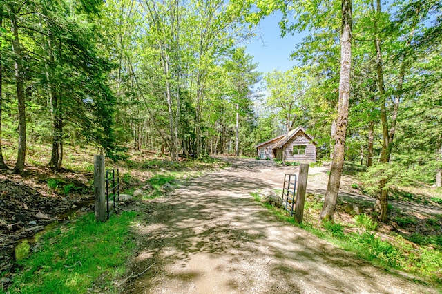 543 Middle Rd, Dresden, ME 04342 - view of dirt / gravel driveway featuring a gated entry and a view of trees