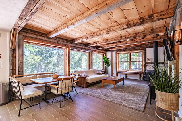 543 Middle Rd, Dresden, ME 04342 - dining area featuring wood finished floors, wood ceiling with exposed beams, and a wood stove