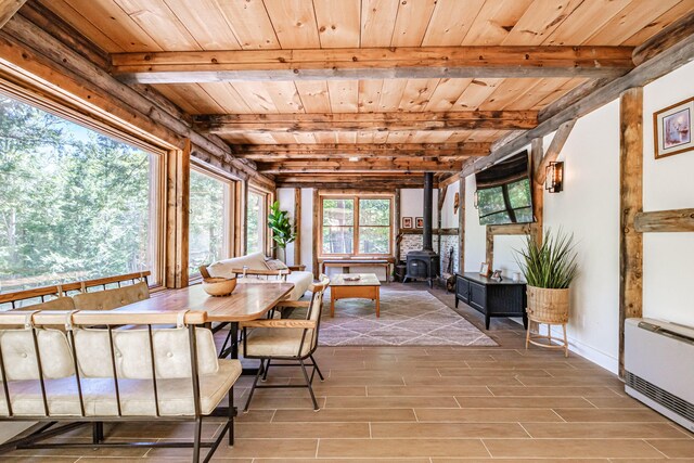 543 Middle Rd, Dresden, ME 04342 - sunroom / solarium with beamed ceiling, a wood stove, and heating unit