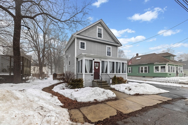 american foursquare style home featuring a sunroom