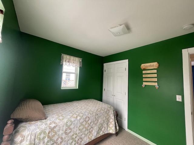 bedroom featuring a closet, carpet flooring, and baseboards