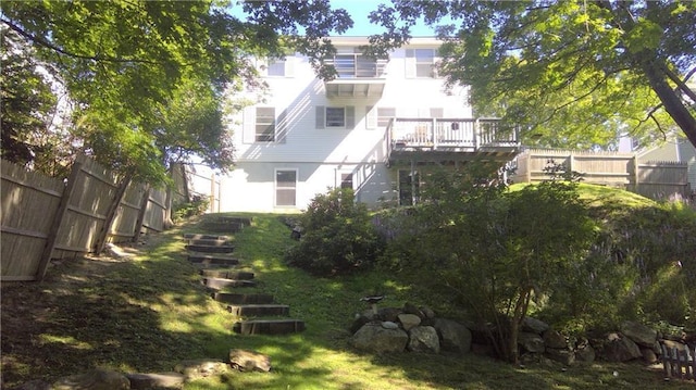 view of yard featuring fence and stairway