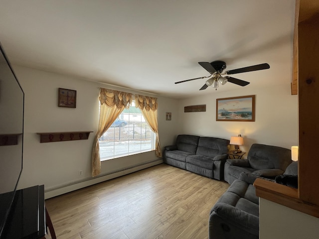 living area with a baseboard heating unit, light wood-style floors, and a ceiling fan