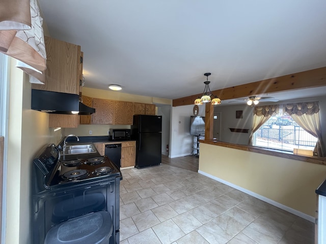 kitchen featuring baseboards, hanging light fixtures, ventilation hood, black appliances, and a sink