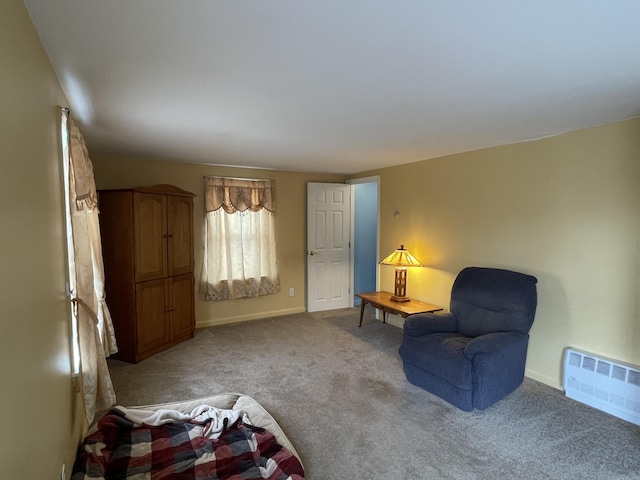 living area featuring light carpet and baseboards