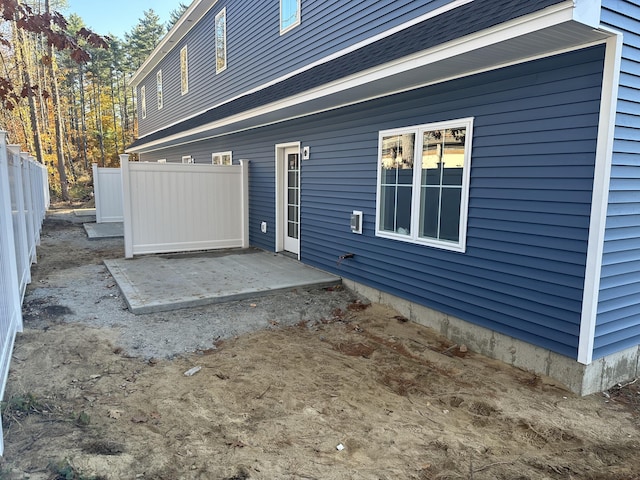 rear view of house featuring a patio and fence