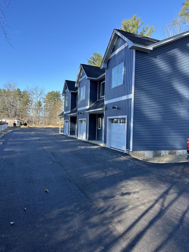 view of side of home featuring an attached garage and board and batten siding