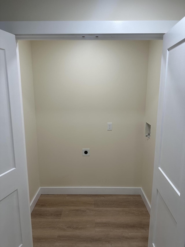 laundry room with baseboards, laundry area, wood finished floors, and hookup for an electric dryer