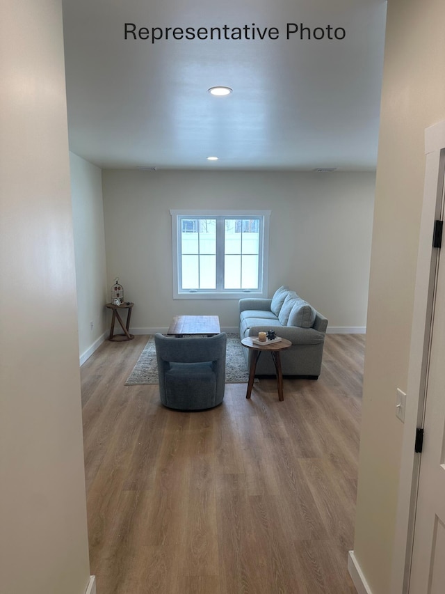 sitting room with recessed lighting, baseboards, and wood finished floors