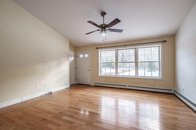 empty room featuring light wood-style floors, lofted ceiling, baseboards, and a ceiling fan