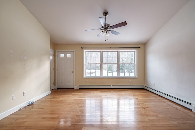 interior space featuring light wood-type flooring, a baseboard radiator, baseboards, and ceiling fan