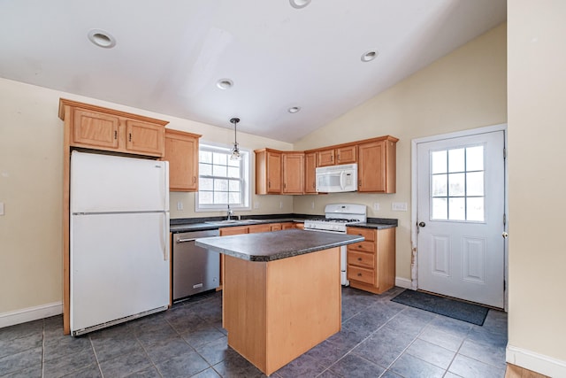 kitchen featuring lofted ceiling, white appliances, a sink, a center island, and dark countertops