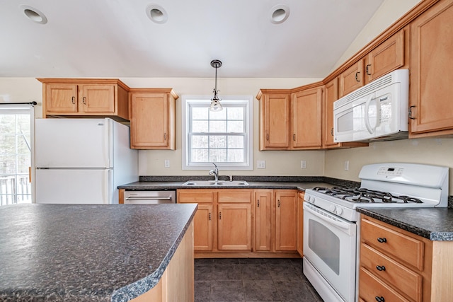 kitchen featuring decorative light fixtures, dark countertops, vaulted ceiling, a sink, and white appliances