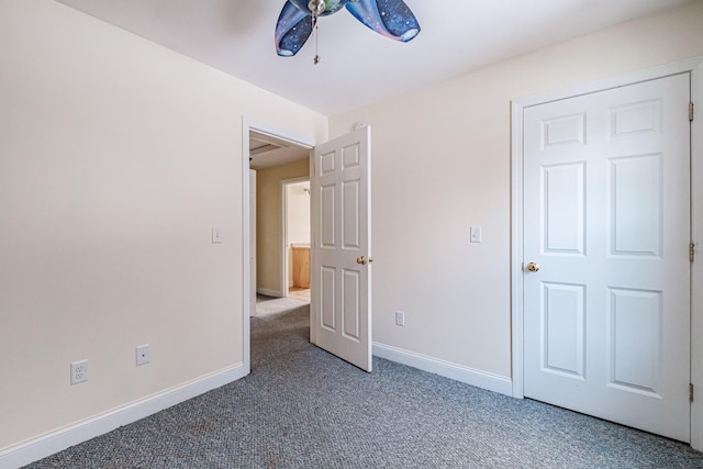 unfurnished bedroom with carpet, baseboards, and ceiling fan