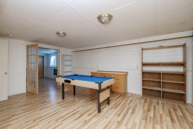 rec room with a drop ceiling and light wood-style flooring