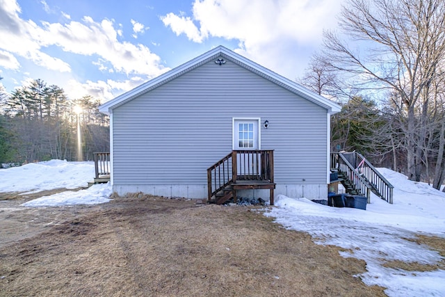 view of snow covered back of property