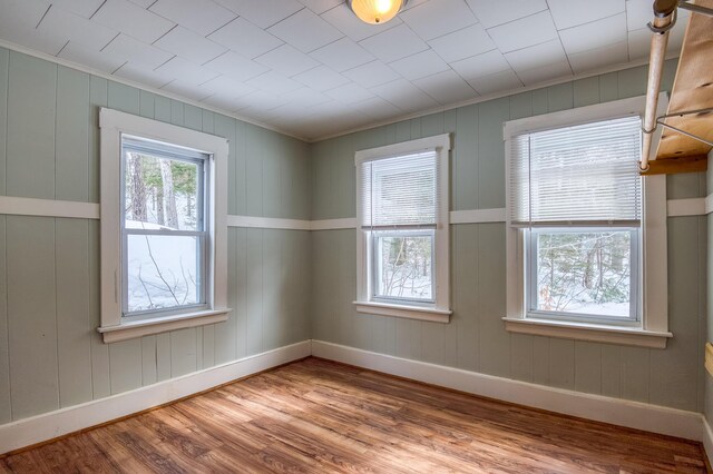 spare room featuring wood finished floors and baseboards