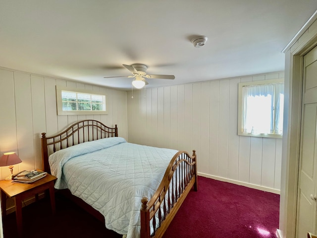 bedroom featuring multiple windows, a ceiling fan, and carpet flooring