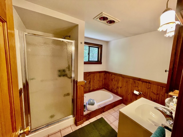 bathroom with a garden tub, wooden walls, wainscoting, a shower stall, and tile patterned floors