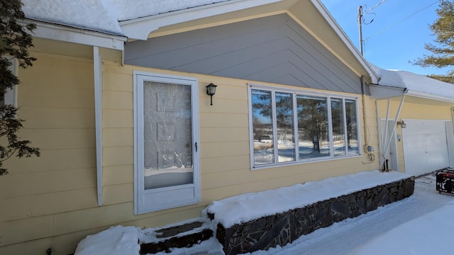 view of snow covered property entrance