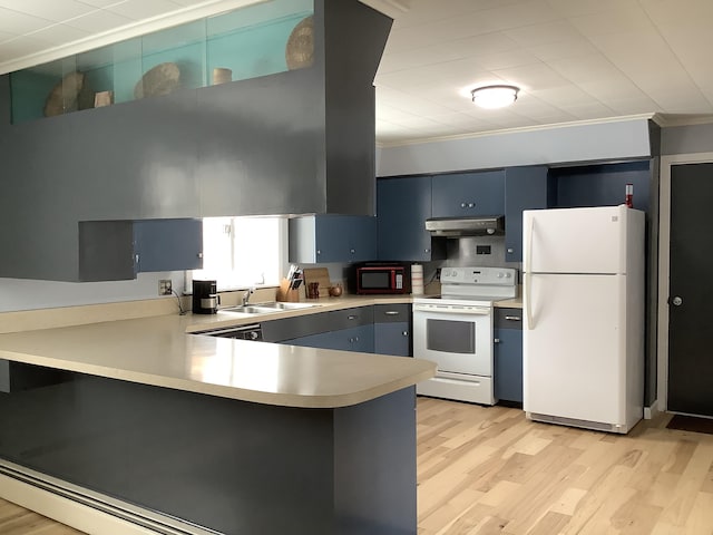 kitchen with a peninsula, white appliances, blue cabinets, and a sink