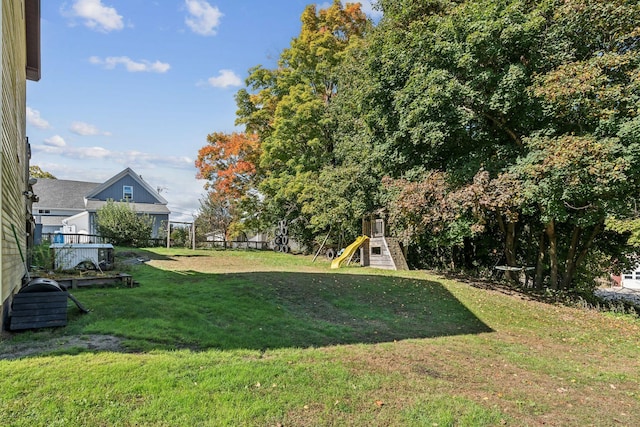 view of yard with a playground and fence