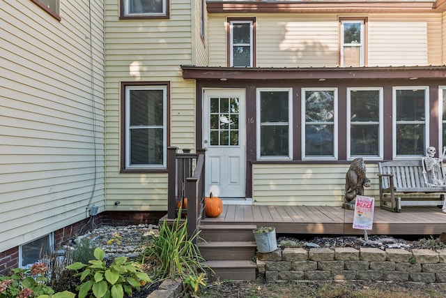 view of exterior entry featuring a deck