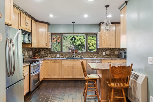 kitchen with tasteful backsplash, dark wood-style floors, stainless steel appliances, light brown cabinetry, and a sink