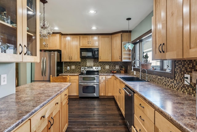 kitchen featuring backsplash, dark wood finished floors, stainless steel appliances, and a sink