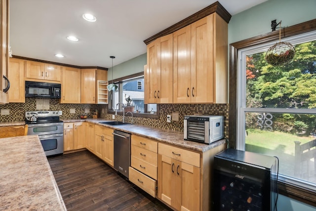 kitchen featuring light brown cabinetry, appliances with stainless steel finishes, a sink, and decorative backsplash