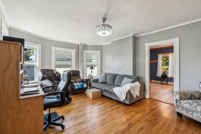 office space with light wood-style floors, a baseboard radiator, plenty of natural light, and crown molding