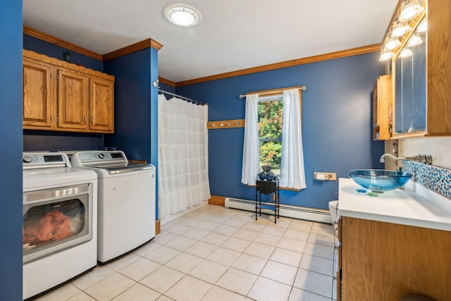 washroom with light tile patterned floors, a baseboard radiator, ornamental molding, separate washer and dryer, and laundry area