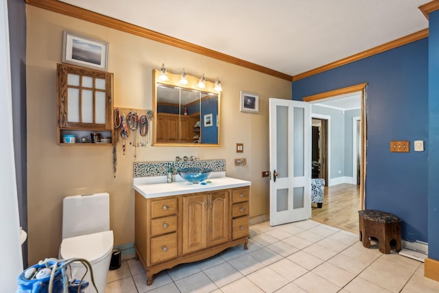 bathroom with french doors, crown molding, toilet, and tile patterned floors