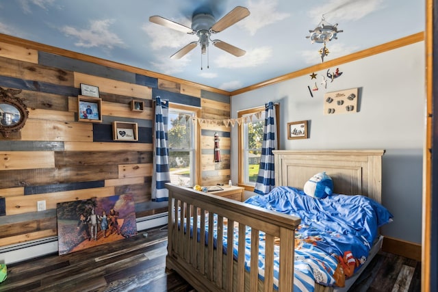 bedroom featuring wood walls, baseboards, ornamental molding, and wood finished floors