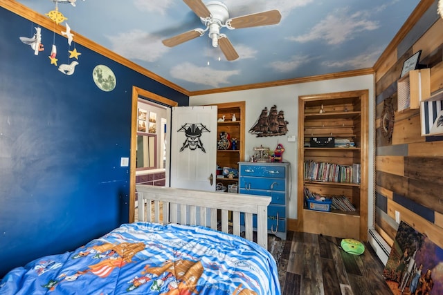 bedroom with a baseboard heating unit, a ceiling fan, ornamental molding, and wood finished floors