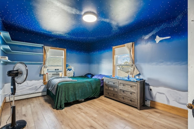 bedroom with baseboards, a baseboard radiator, cooling unit, and wood finished floors