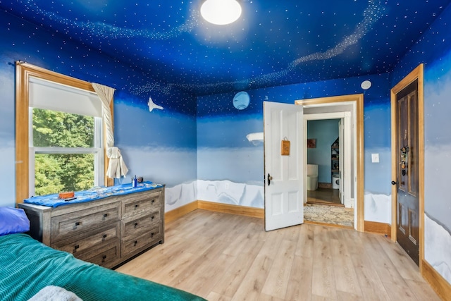 bedroom featuring baseboards and wood finished floors