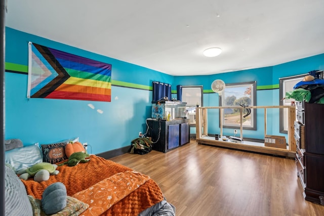 bedroom with baseboards and wood finished floors