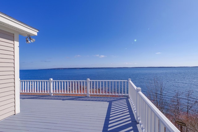 wooden terrace featuring a water view