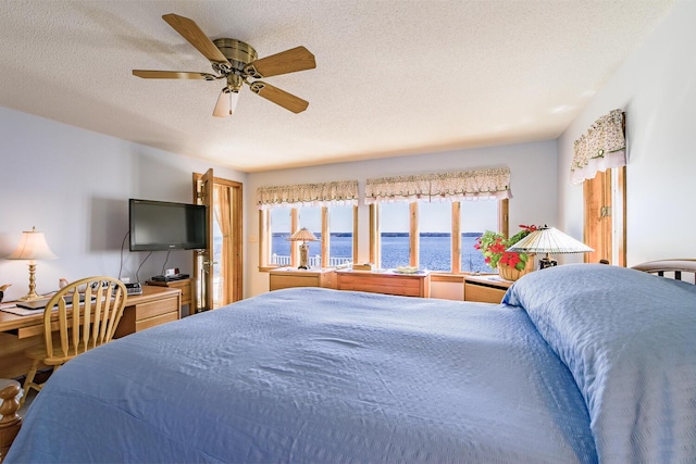 bedroom featuring a textured ceiling and a ceiling fan