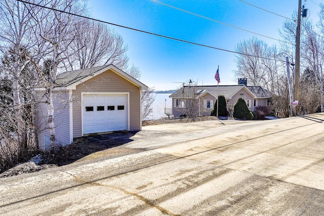 ranch-style house with an outbuilding, driveway, and a detached garage