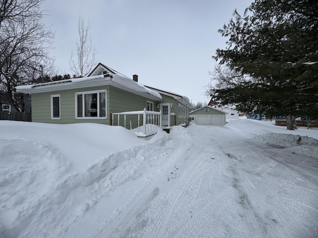 snow covered house with a garage