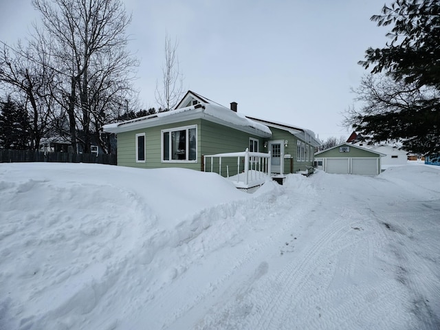 exterior space featuring a detached garage and an outdoor structure