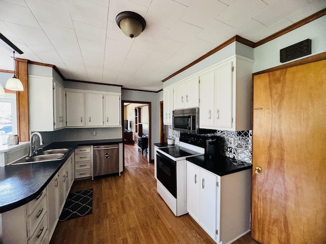30 Washington St, Caribou, ME 04736 - kitchen with stainless steel appliances, a sink, crown molding, dark countertops, and backsplash