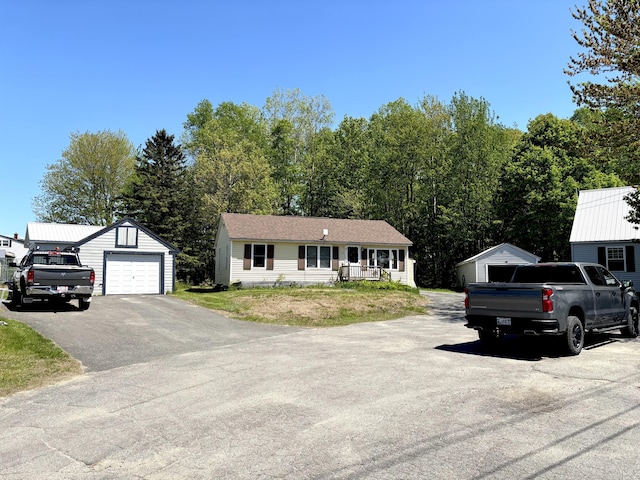 5 Grove St, Millinocket, ME 04462 - view of front of house with an outdoor structure, a garage, driveway, and a porch