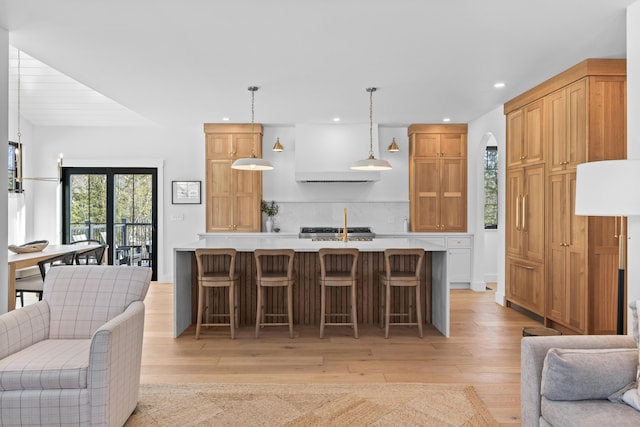 65 Sky Dr, Windham, ME 04062 - kitchen with light wood-type flooring, decorative backsplash, open floor plan, and light countertops