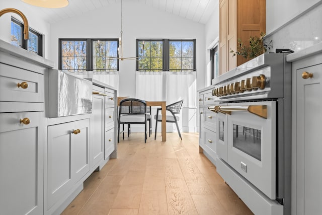 65 Sky Dr, Windham, ME 04062 - kitchen featuring white range, light countertops, light wood finished floors, and lofted ceiling