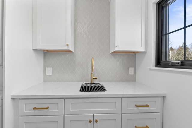 65 Sky Dr, Windham, ME 04062 - details featuring light stone counters, white cabinets, and decorative backsplash